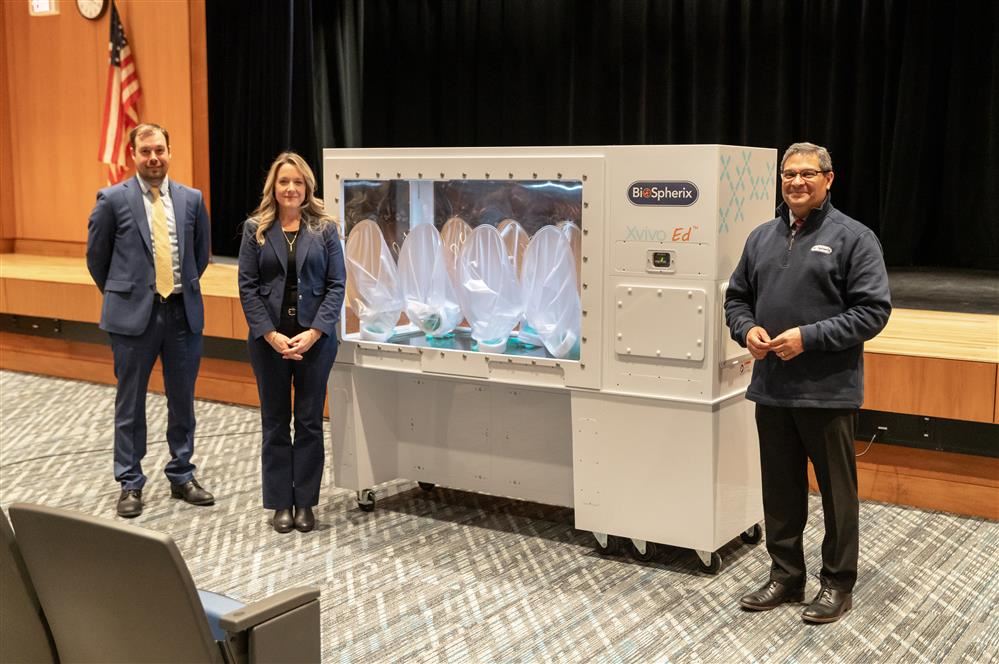 Austin Wheelock, Dr. Ryfun, and Ahmed Mustafa stand with the new XVivo Ed.
